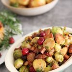 Cranberry, Chestnut and Tofu 'bacon' Brussel Sprouts with potatoes in backgrouns