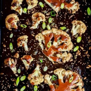 Roasted Cauliflower steaks with miso glaze on a tray.