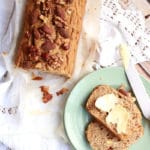 Vegan Banana Bread with a slice cut off and buttered