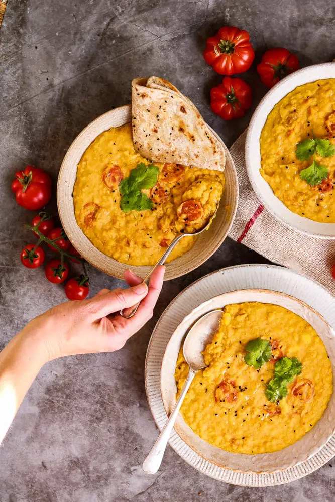 Daal with roti and my hand scooping up a spoonful.