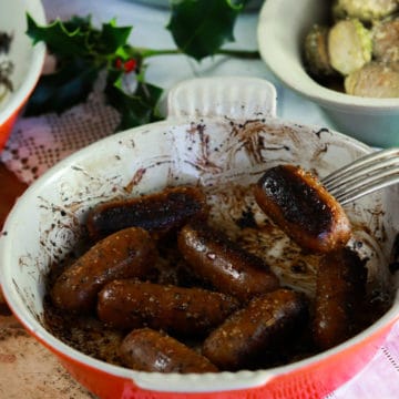 Vegan Sausages with sticky mustard glaze in a roasting dish.