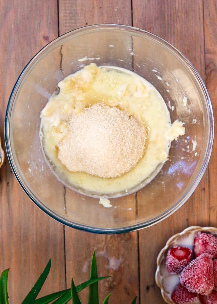 Image showing adding sugar to banana bread batter.