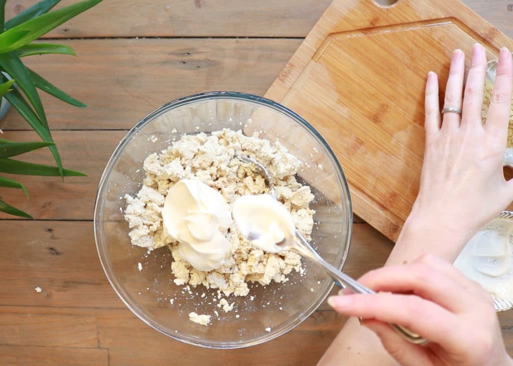 Showing adding vegan mayo to the tofu.