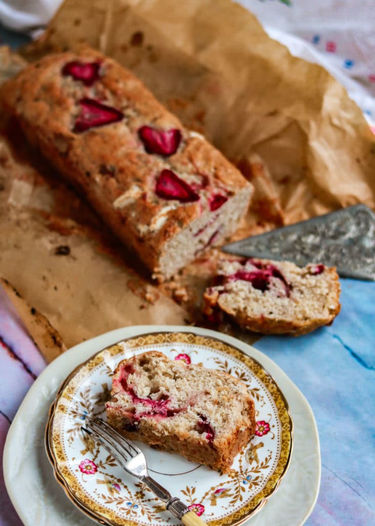 Strawberry and White Chocolate Banana bread with a slice cut. 