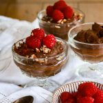 black bean mousse in a pot topped with raspberries