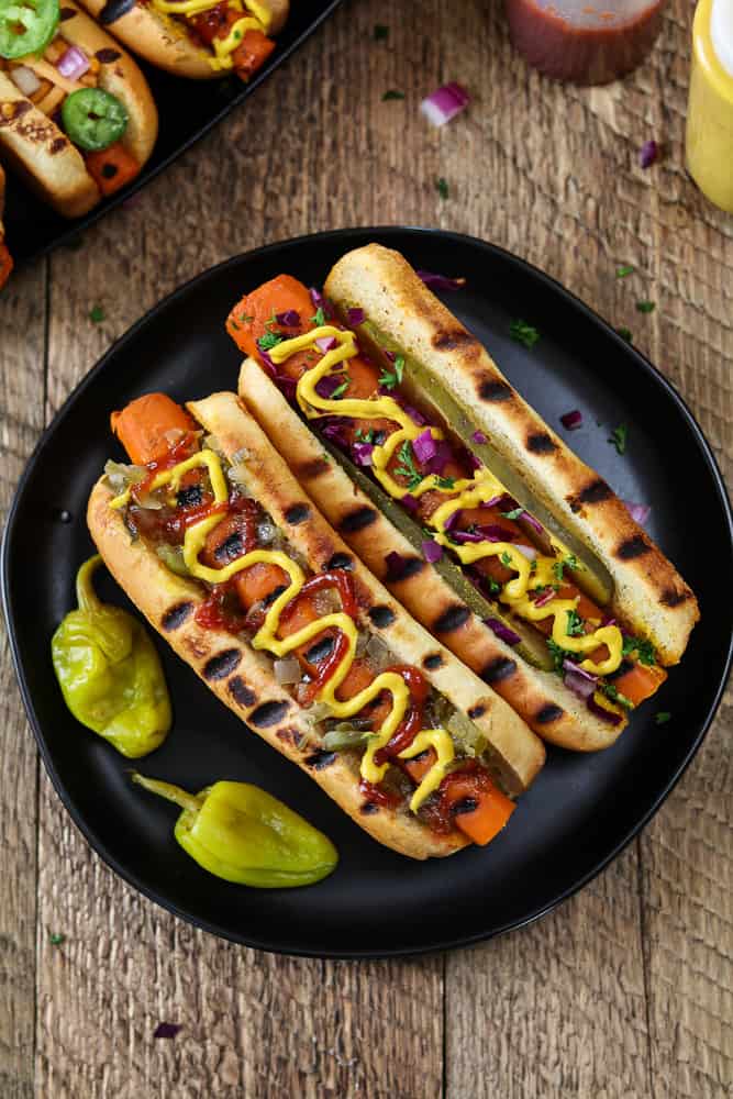 carrot hot dogs on a plate with mustard