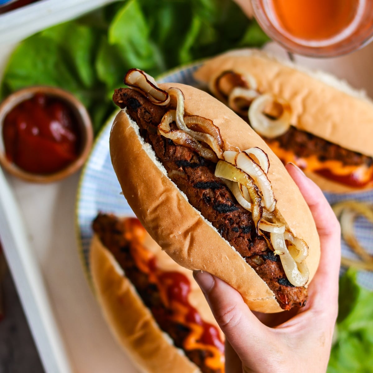 Seitan sausage in a hot dog bun with fried onions