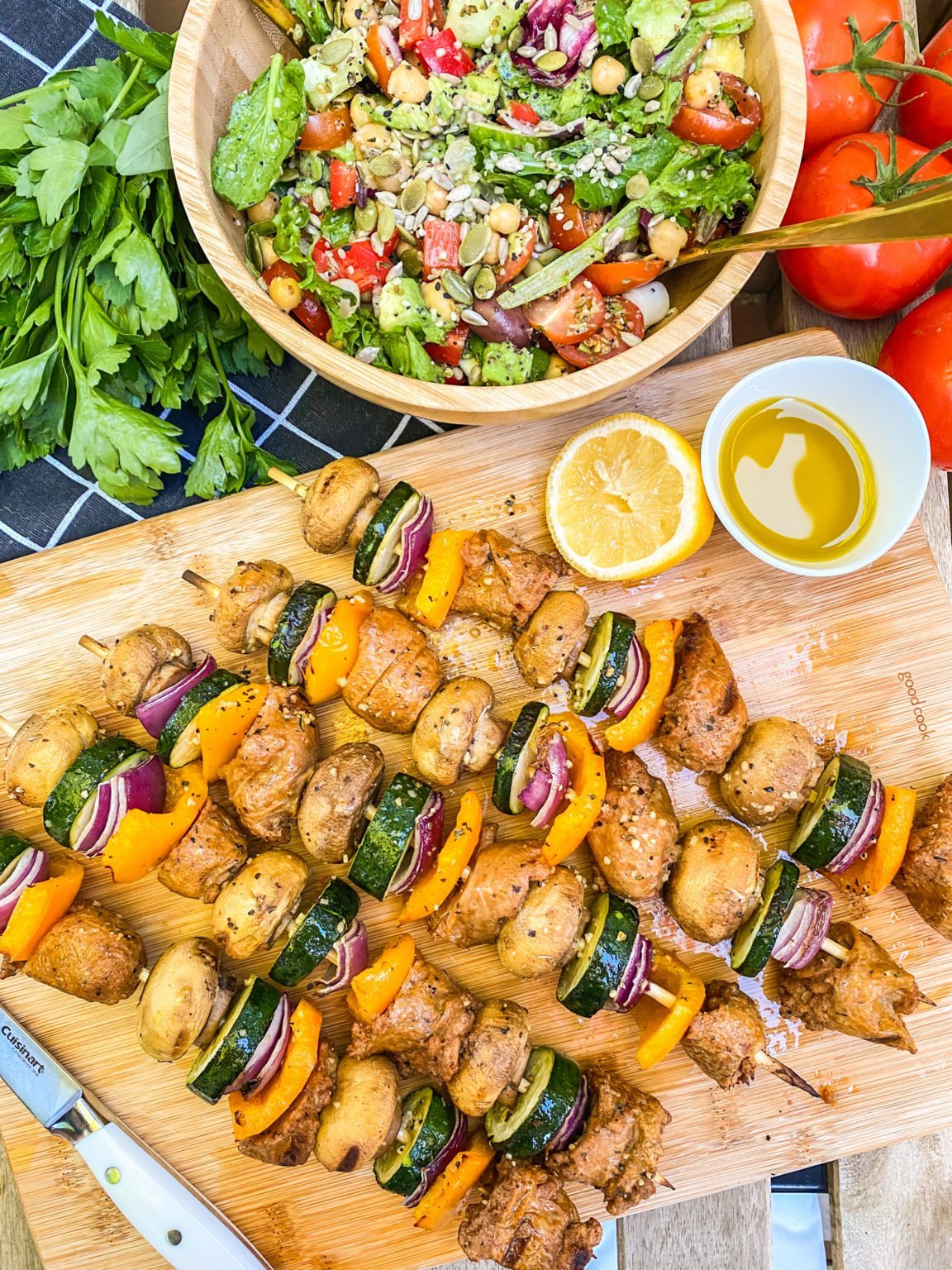 vegan tofu skewers on a wooden board with salad