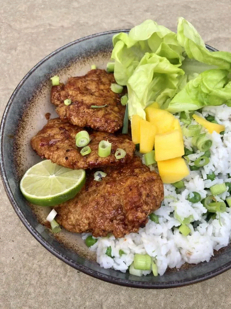vegan seitan jerk chicken on a plate with rice and salad