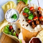 a vegan wrap made with roti, filled with jerk tempeh