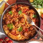 Image of vegan spaghetti and meatballs in Zim's Tribe nigerian style sauce.