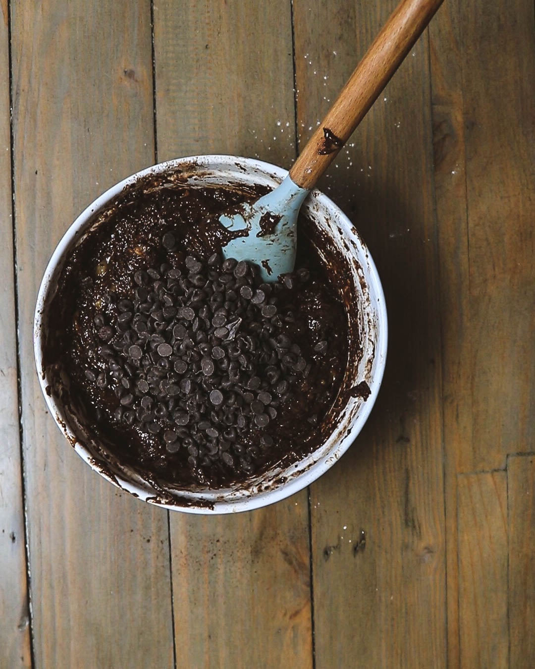 The bowl with the chocolate chips in the banana brownie batter.