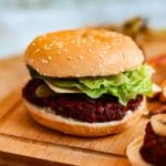 A lentil and beetroot burger on a bun.
