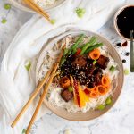 A bowl of noodles with black bean tofu and crunchy veggies.