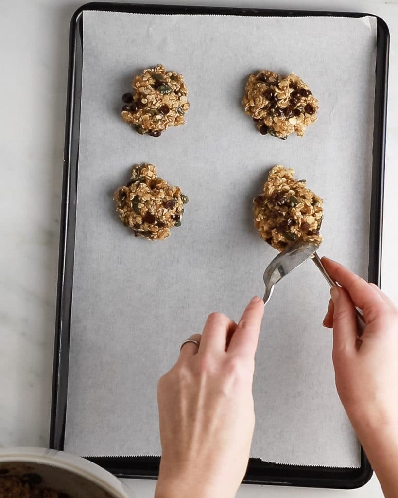 Image showing the cookie dough being put onto a baking sheet, ready to cook.
