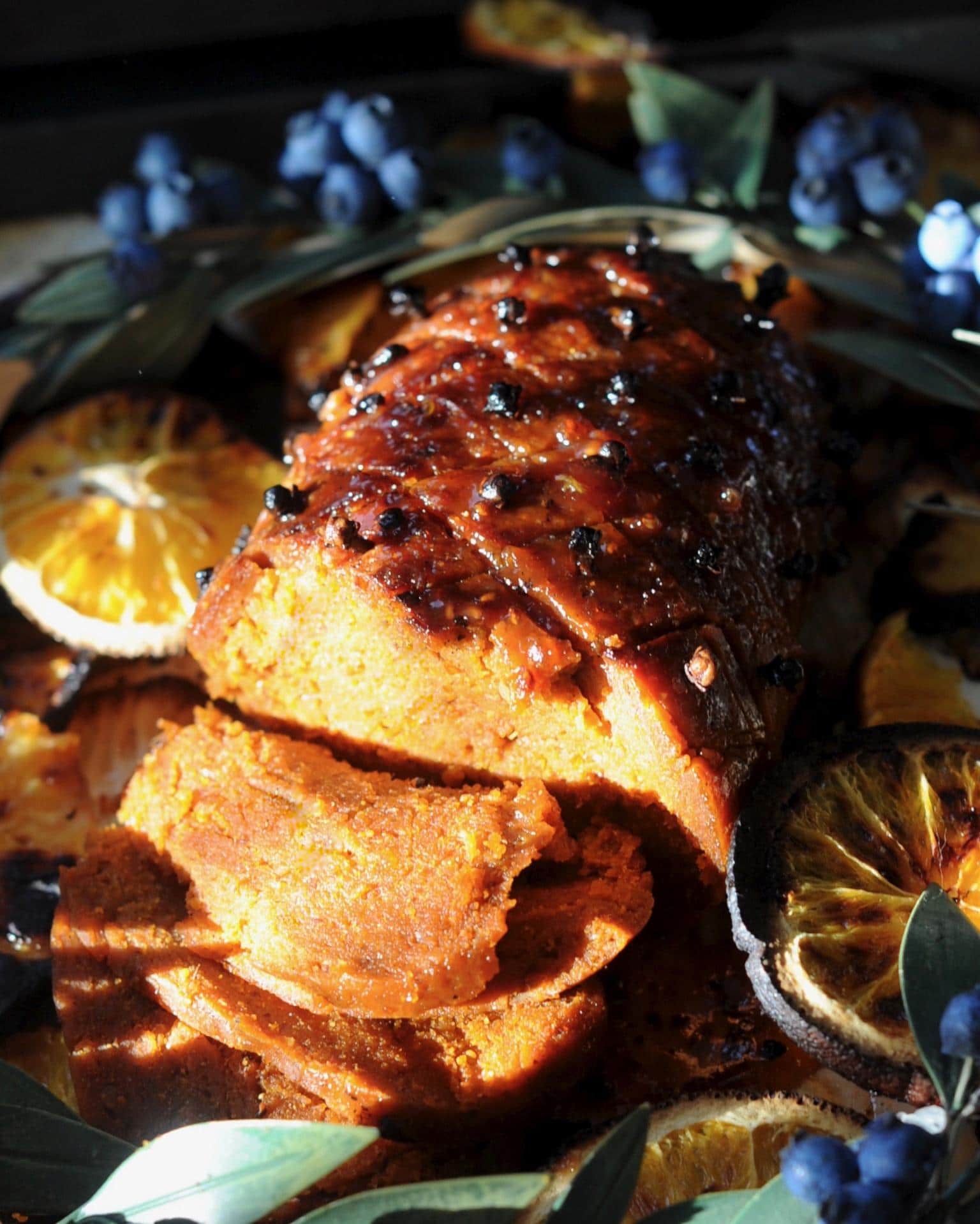 Vegan roast dinner with slices cut into it.