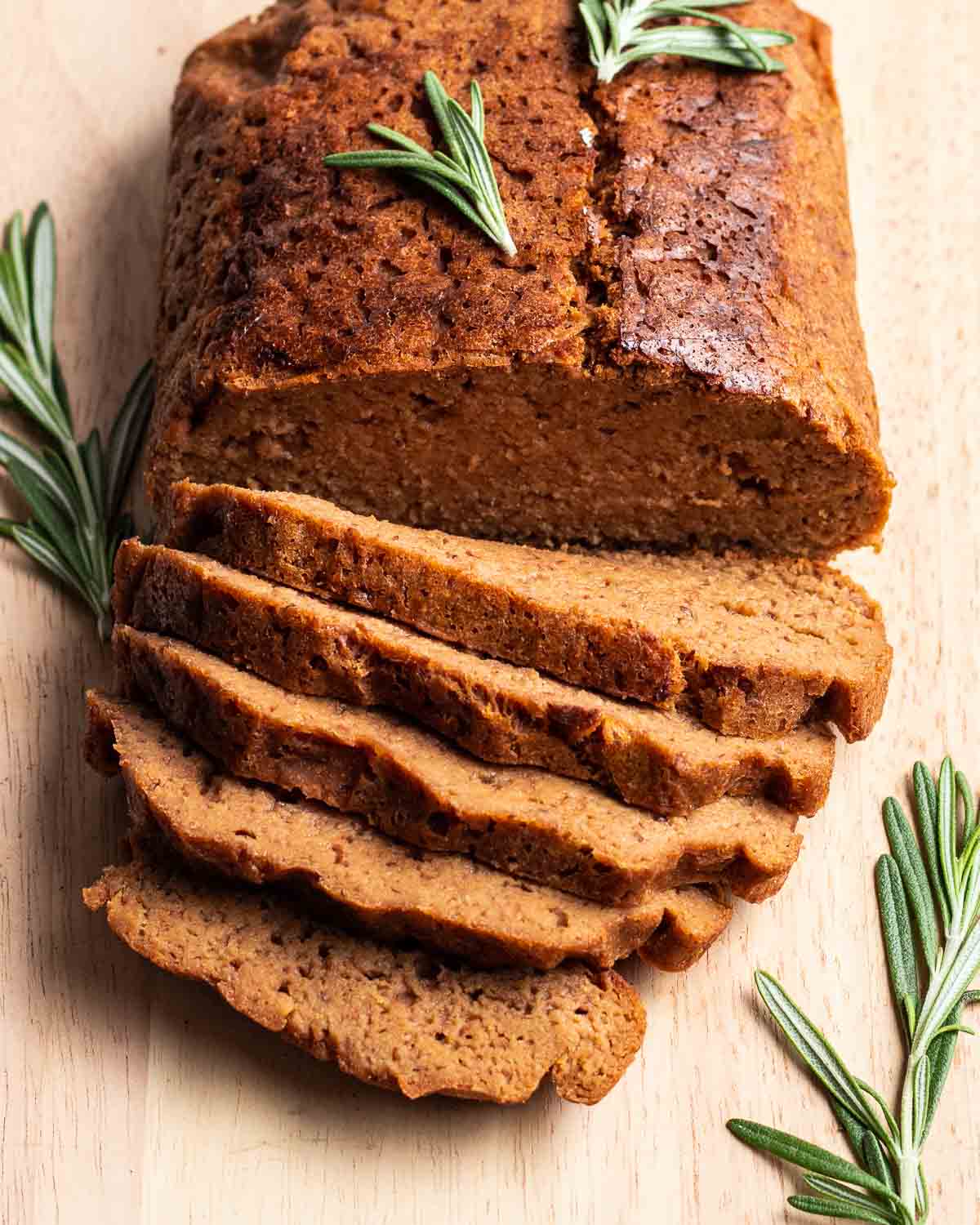 Vegan Roast Beef slices up with whole rosemary stems.