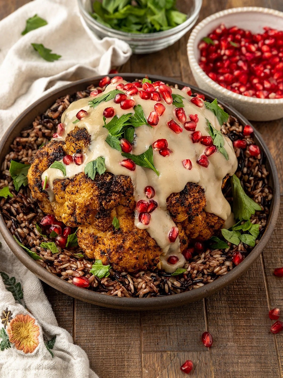 Whole roasted cauliflower with pomegranate seeds and wild rice.