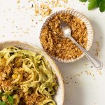 A little dish of pangritata and a bowl of pasta next to it.