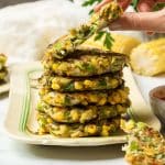 A stack of vegan corn and courgette fritters.