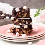 A stack of vegan rocky road on a pink plate.