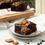 A vegan biscoff brownie on a plate, really needs to be eaten asap!