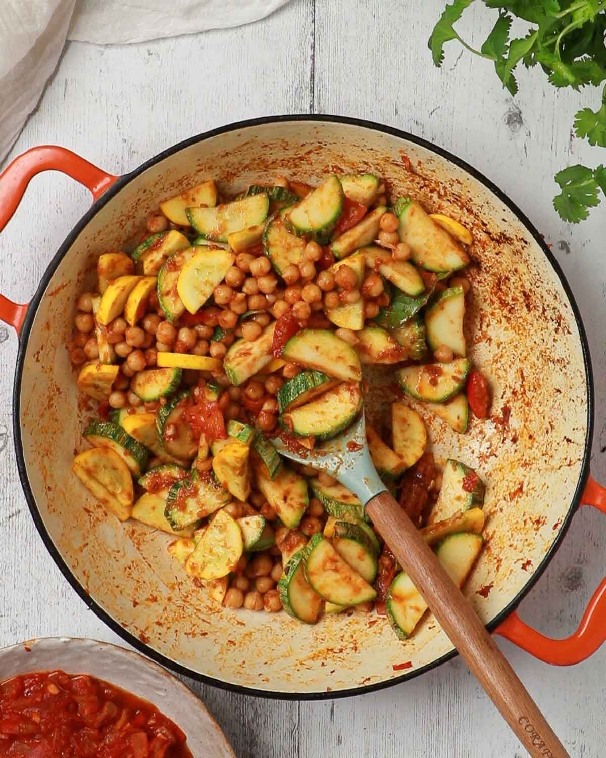 Add the courgettes to the chickpeas and mix to coat in the spices.