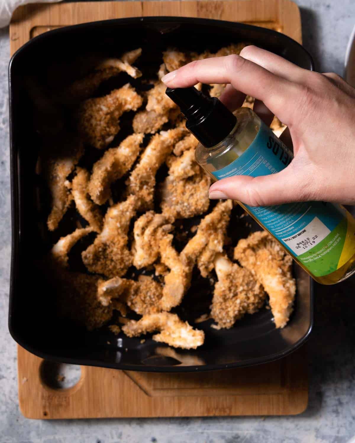 Add the mushrooms to the air fryer basket and spritz with a little extra oil. Then air fry.