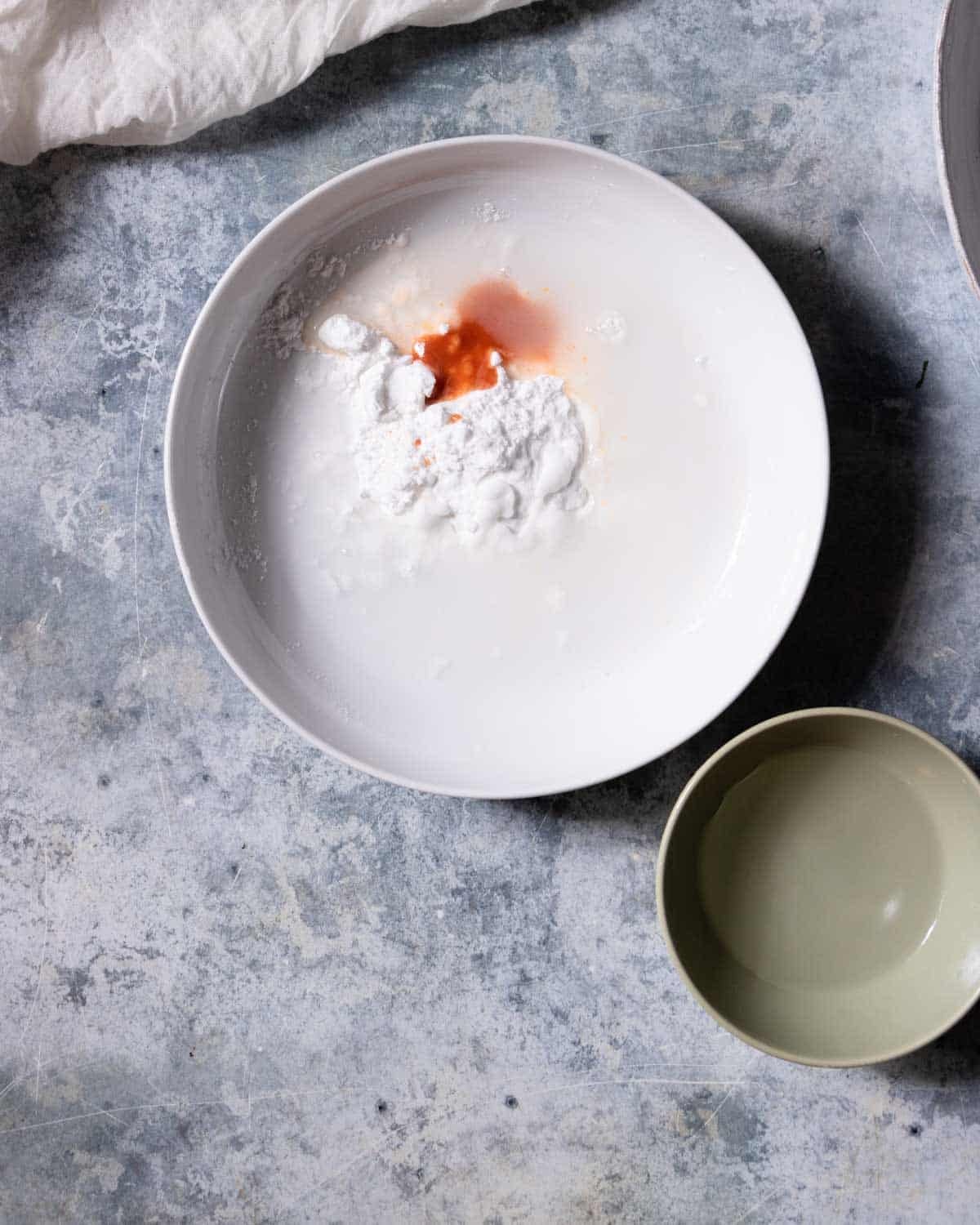 Add water to the potato starch in a bowl and mix.