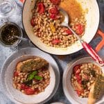 Plates of roasted tomato and white bean stew ready to eat.