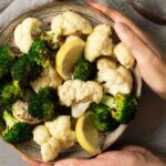 Cauliflower and broccoli being served on a plate.
