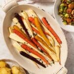 Roasted carrots and parsnips in an oven proof serving dish, ready to eat.