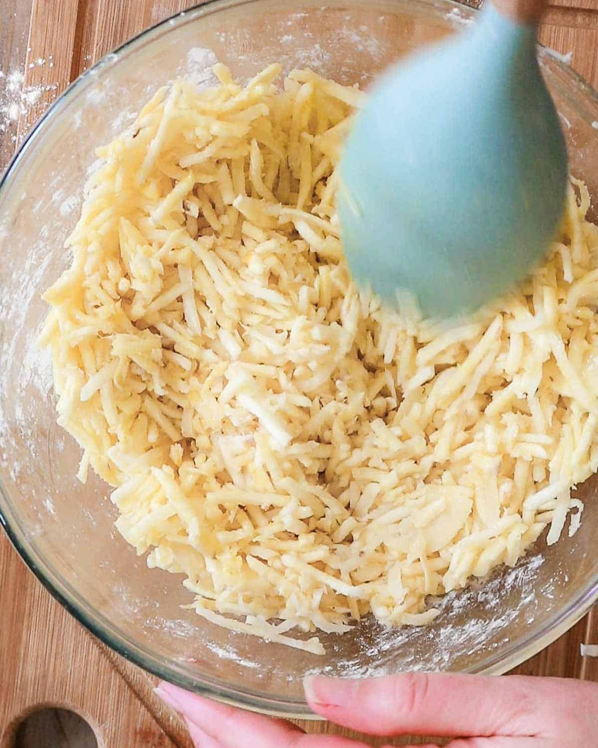Adding the chickpea flour, oil and salt to the grated mixture.