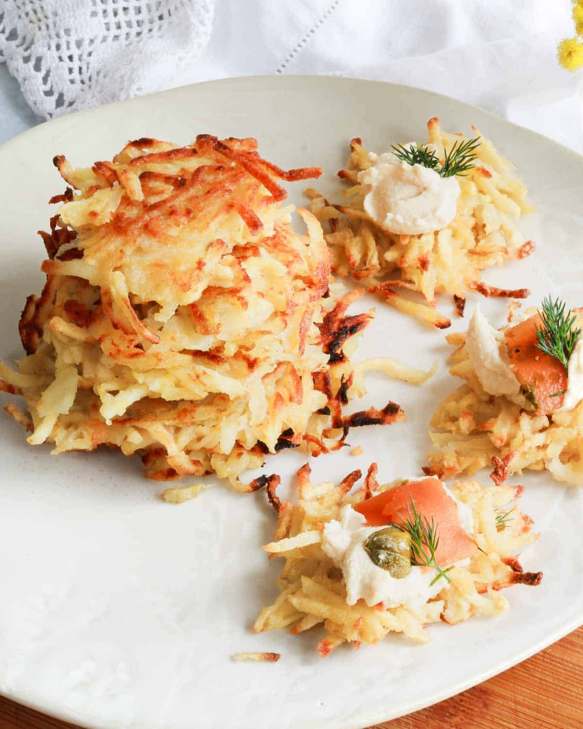 A stack of fritters with some that have vegan lox on top. 