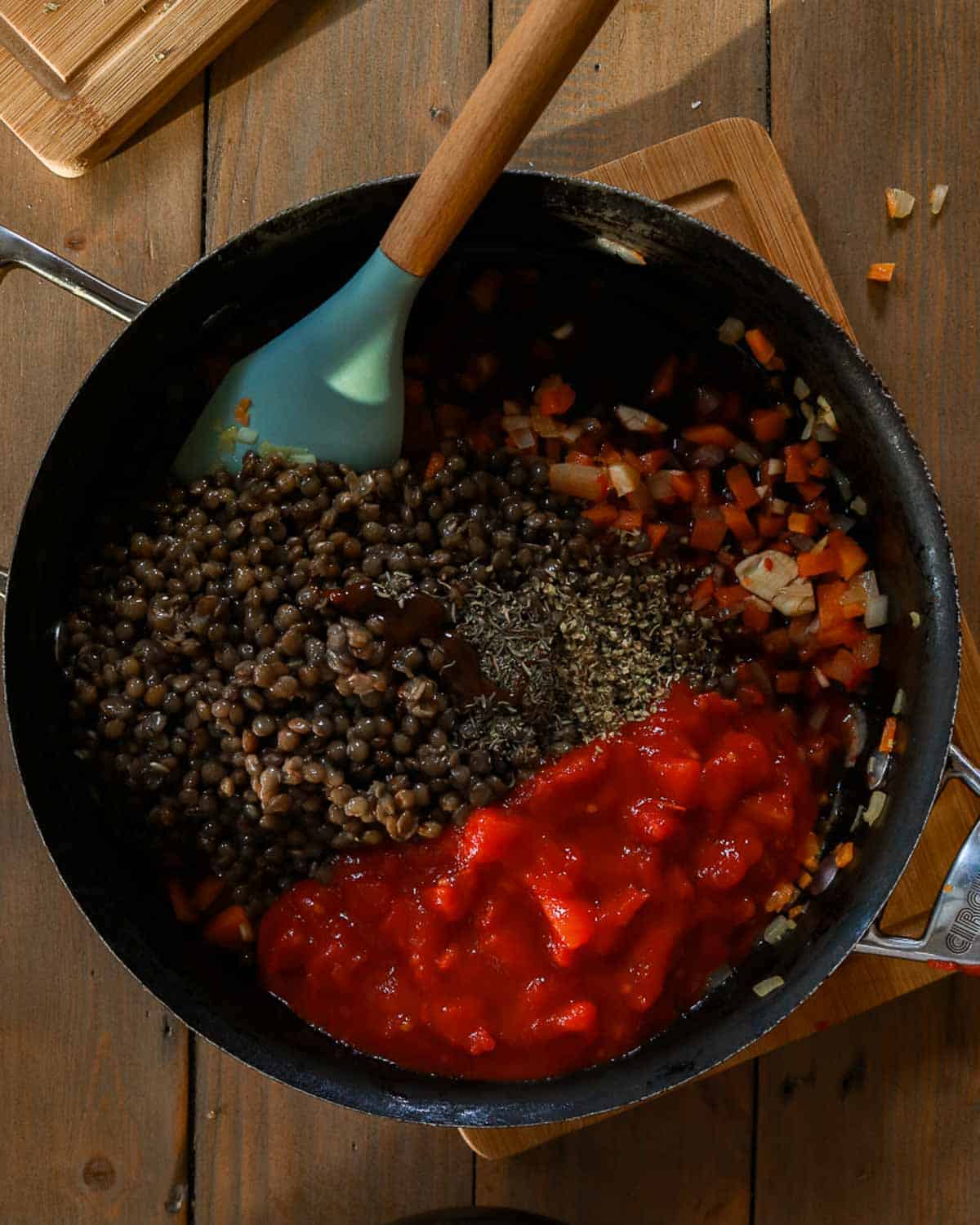 The lentils and herbs have been added to the bolognese.