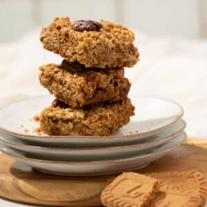 A stack of biscoff flapjacks on a plate ready to eat.