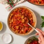 Butterbean Stew with a spoon scooping up some stew.