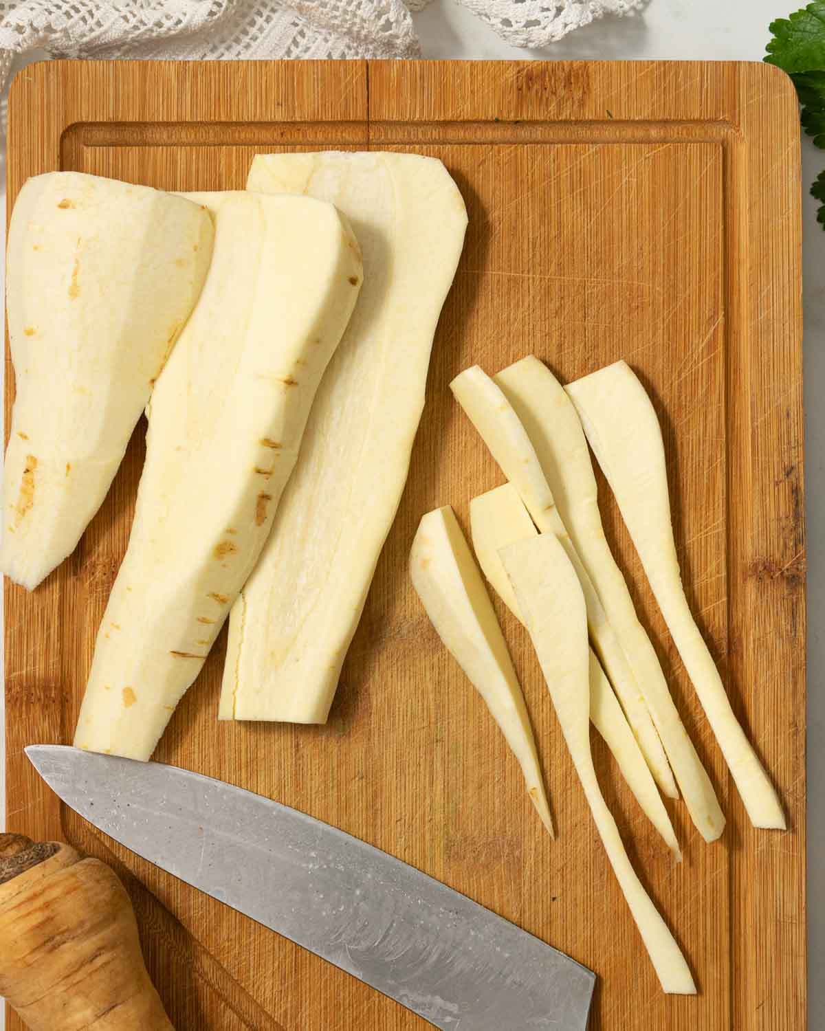 Parsnips being cut into chunks or fries.