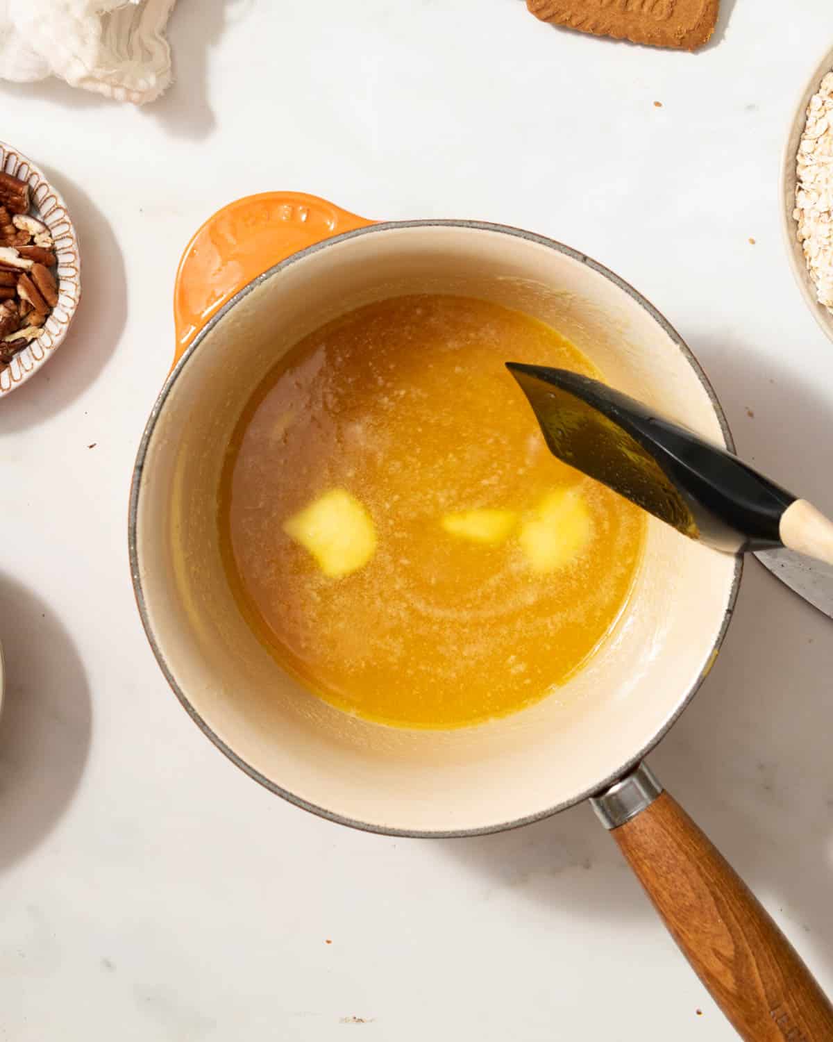 Melt butter and golden syrup in a saucepan.