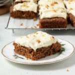A piece of cake with vegan cream cheese frosting on it.