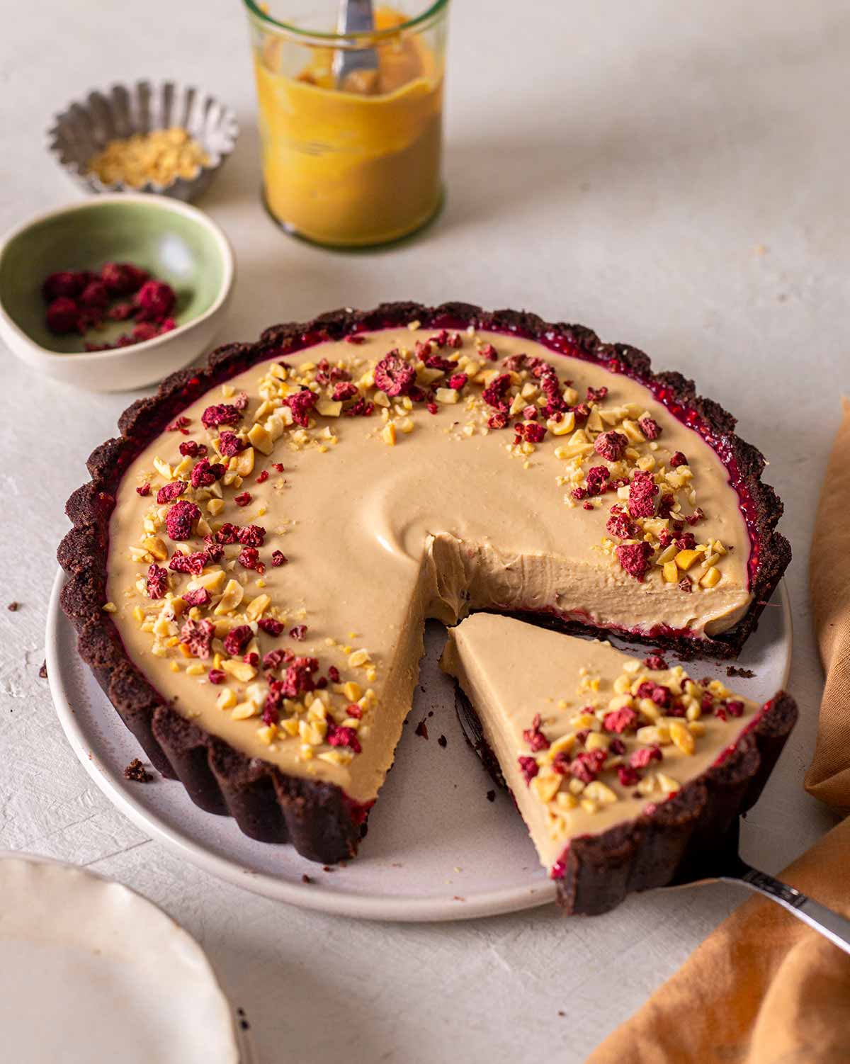 Peanut Butter Pie with Raspberry jam being sliced.