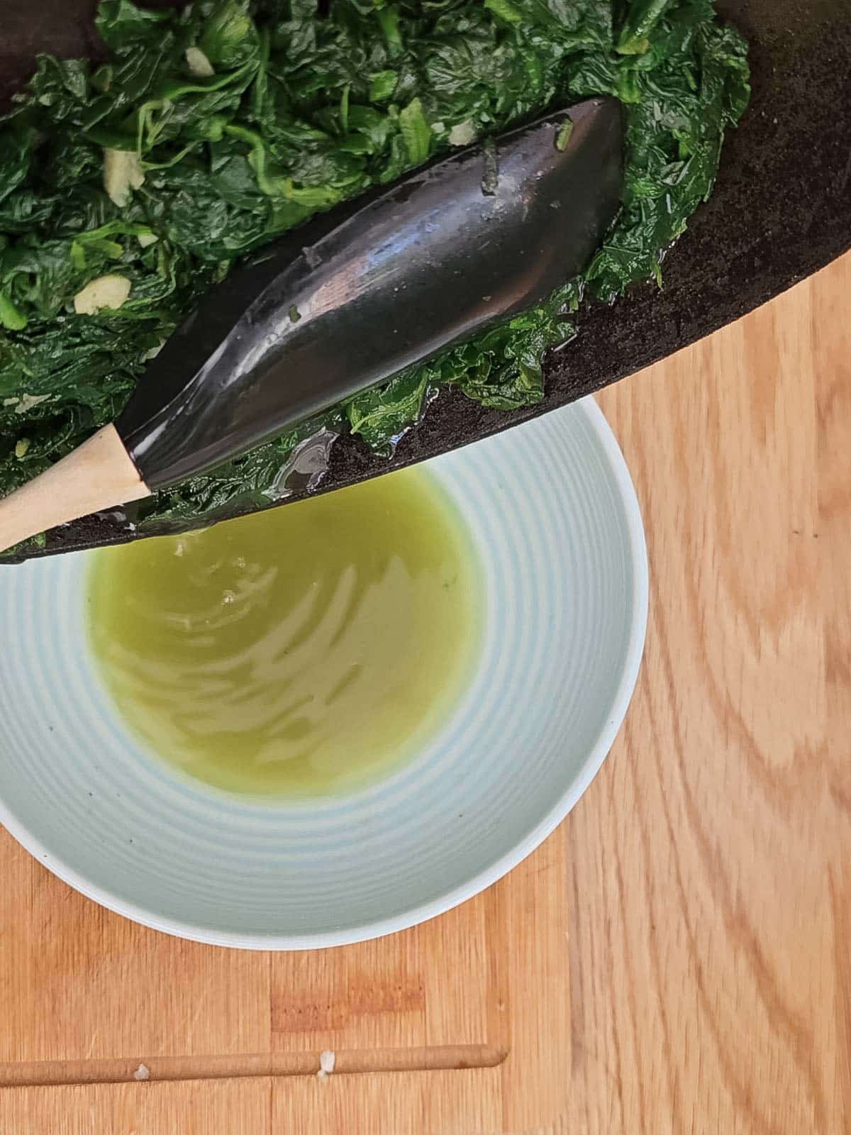 The spinach being drained.