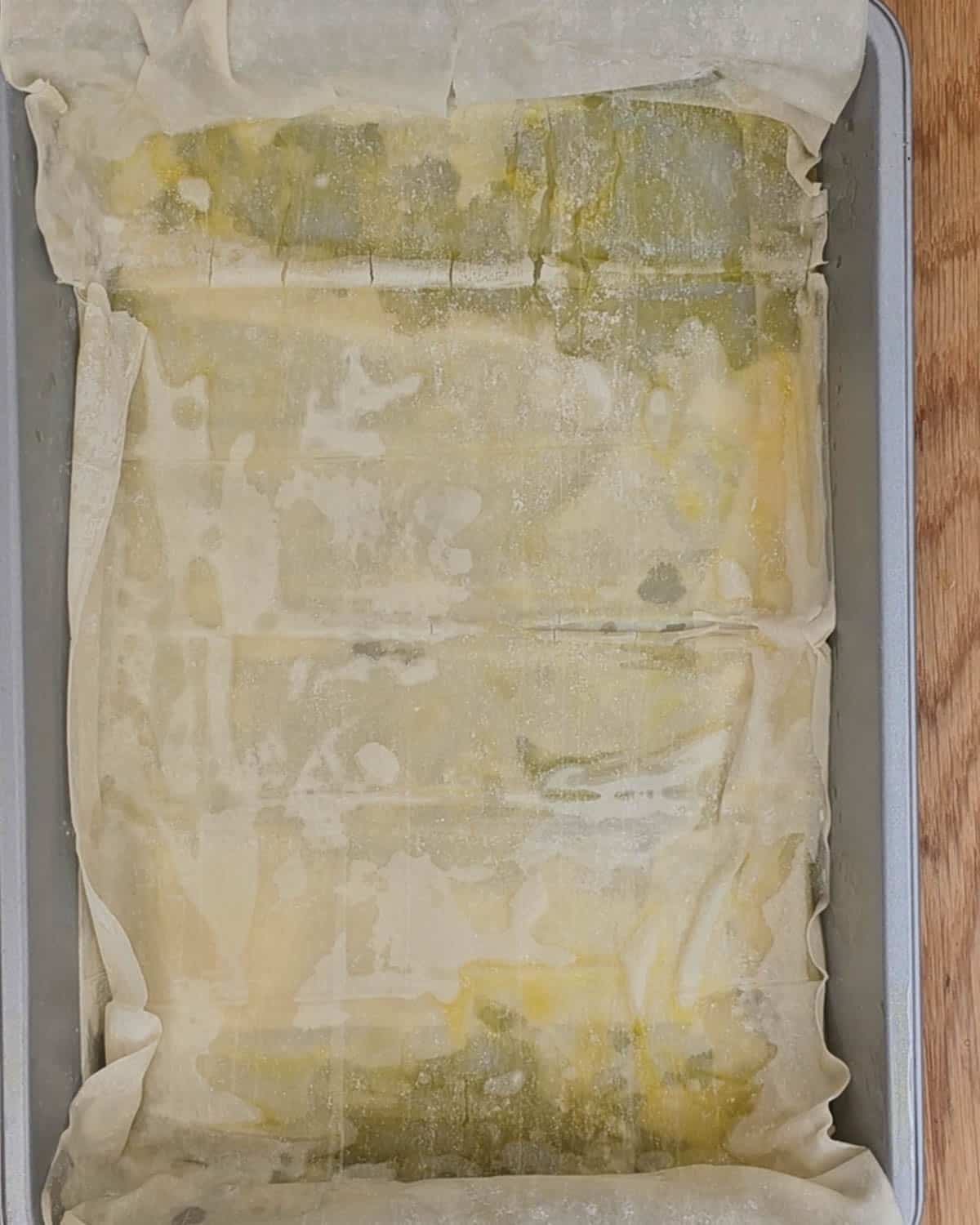 Lay out the filo pastry in a tin.