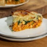 A slice of chickpea and butternut squash filo pie ready to eat on a plate.