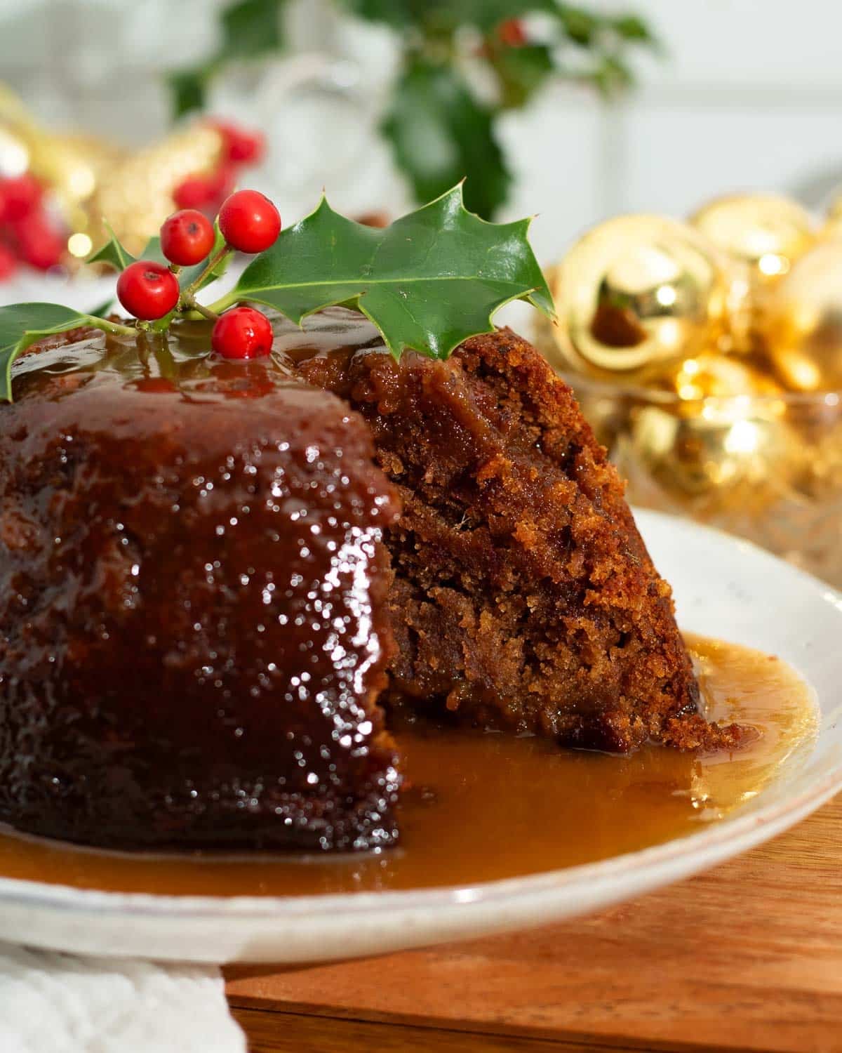 A Christmas version of the sticky toffee pudding with a slice taken out of it.