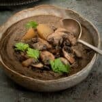 A bowl of vegan mushroom and potato soup ready to eat.