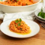 Grated carrot salad on a little plate ready to eat.