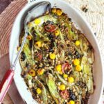 A dish of leek and fennel gratin with olives ready to eat.