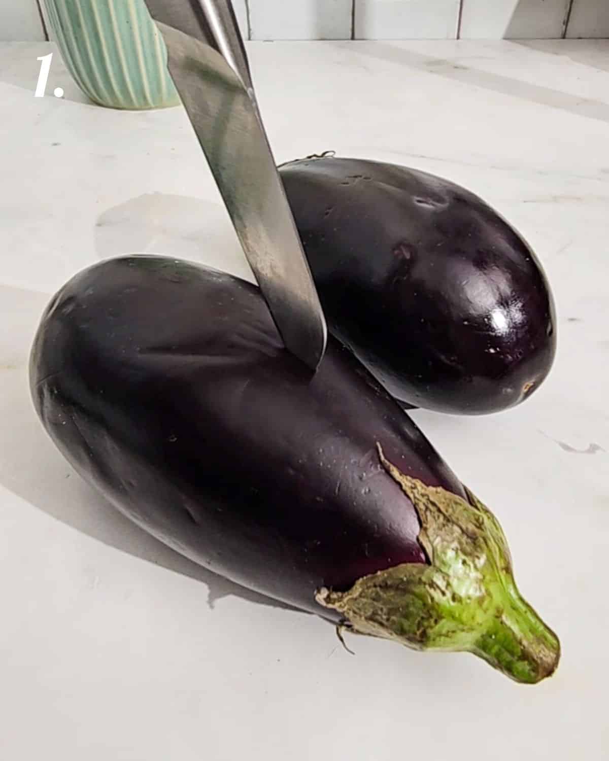 Poking holes in the eggplant before roasting in the air fryer.
