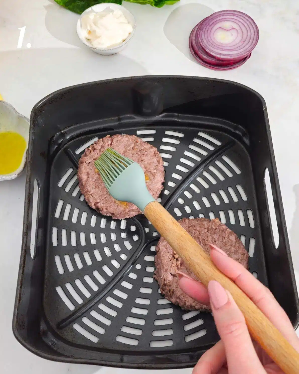 Brush the burgers with a little oil before adding to the air fryer.